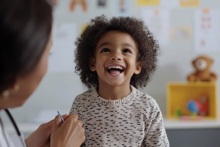 A happy Black child sits confidently on the examination table as a doctor checks their throat with a tongue depressor. The office is warm and welcoming, filled with toys and educational posters, creating a calm atmosphere.の素材