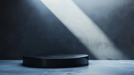 A glossy black podium, lit from above with soft white light, against a gradient background from gray to navy blue. The modern design and muted colors create a sophisticated and elegant look.の素材