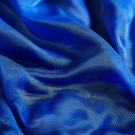 Close-up of a sports clothing fabric in electric blue, featuring a diagonal mesh texture for extra ventilation, perfect for high-performance clothing.の素材