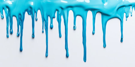 Cool shades of blue and aqua paint drip down a clean white surface, leaving a serene space for text at the top of the imageの素材