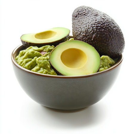 A bowl of freshly made guacamole with visible avocado chunks, isolated on a white background, showcasing a classic dipの素材