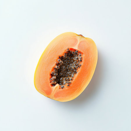 A fresh papaya slice with seeds, isolated on a white background, showing a tropical fruit choiceの素材