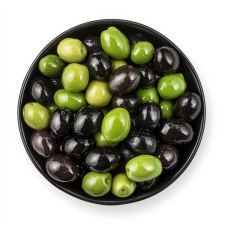 A bowl of mixed olives in black and green, isolated on a white background, emphasizing a Mediterranean snackの素材