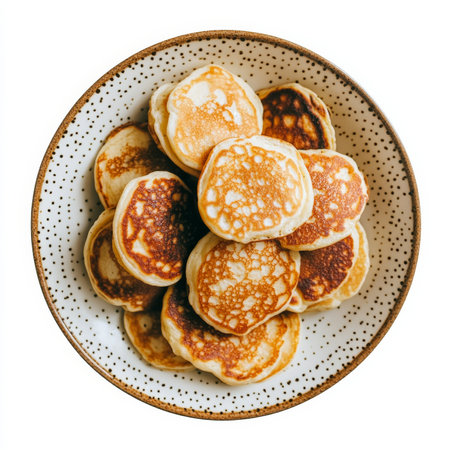 A plate of fluffy buttermilk pancakes, isolated on a white background, showcasing a breakfast classicの素材