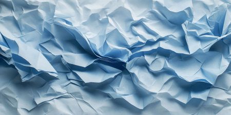 Icy blue crumpled paper texture with frosty shades. Subtle folds and creases evoke a cool and textured feel.の素材