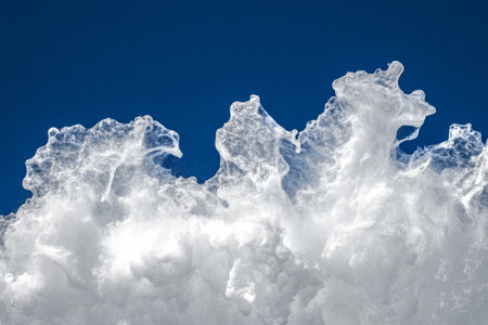 Ocean wave foam texture, dynamic white froth over deep blue water, capturing motion and energyの素材