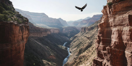 A dramatic canyon with layered red rock formations, a winding river below, and a golden eagle soaring overhead. The rugged and awesome scene captures the grandeur of the natural world.の素材