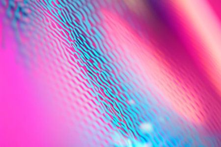 A vibrant neon background featuring glowing blue and pink lines creating a futuristic grid pattern with a soft gradient.の素材