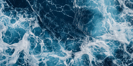 Oceanic blue marble background with white foam-like veins, resembling sea waves.の素材