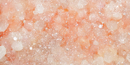 A pale coral glitter background that sparkles delicately with every shift of light. The soft shimmer creates a romantic, elegant atmosphere, ideal for wedding themes, invitations, or high-end fashion campaigns.の素材