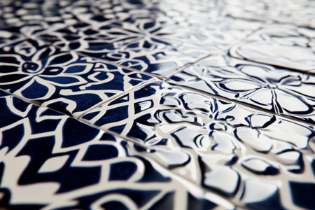 Close-up of glossy ceramic tile texture, reflective surface with deep blue and white patterns.の素材