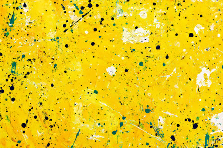 Sunshine yellow paint splatters, scattered randomly for a playful and creative artistic effect.の素材