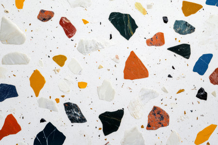A minimalist terrazzo pattern with scattered colorful stone chips embedded in a white cement background.の素材