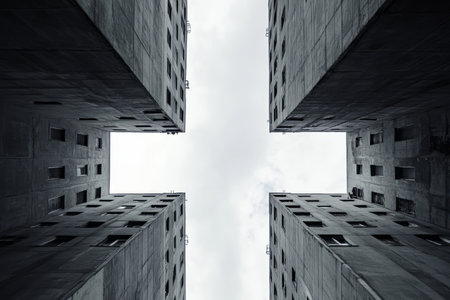 A Soviet-era brutalist architectural background with towering, repetitive concrete apartment blocks under a gray sky.の素材