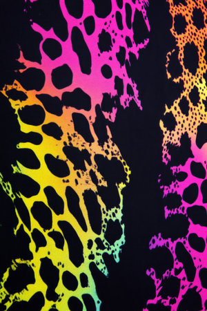 A vibrant animal print pattern with neon leopard spots, set against a deep black background, creating a bold and stylish fashion forward look.の素材