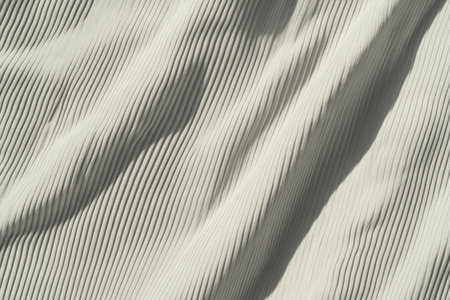 A soft jersey knit fabric texture background in a warm gray tone. The subtle ribbed pattern and natural stretch folds create a relaxed, comfortable aesthetic, ideal for cozy, casual, and athleisure-inspired designs.の素材