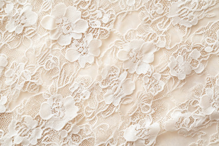 A delicate lace fabric texture background in pale champagne. The intricate floral motifs with fine netting create an elegant, romantic atmosphere, perfect for wedding dresses, vintage fashion, and delicate home decor.の素材