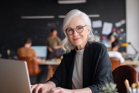 Mature Caucasian woman launching a new CRM system, overseeing rollout and onboarding sessions with various teamsの素材