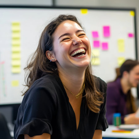 Young adult Caucasian businesswoman laughing with coworkers during a creative brainstorming session, vibrant and open office with whiteboards and post-itsの素材