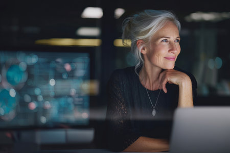 A mature Caucasian woman directs a multi-department initiative, aligning project goals, timelines, and data collection methods for a major platform rollout.の素材