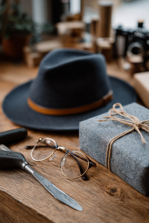 Father's Day display with fashionable hat, glasses, wrapped gift, and tools honoring dadの素材