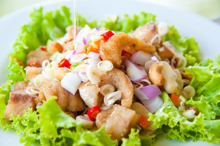 Thai dressed spicy salad with bass, green herbs and nuts : delicious foodの写真素材