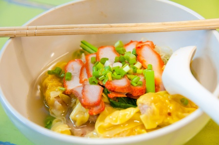 Egg chinese dry noodles with roast red pork, dumpling and vegetablesの写真素材