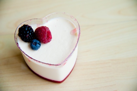 Piece of cake on wood pattern background   Panna Cotta in heart shape cupの写真素材