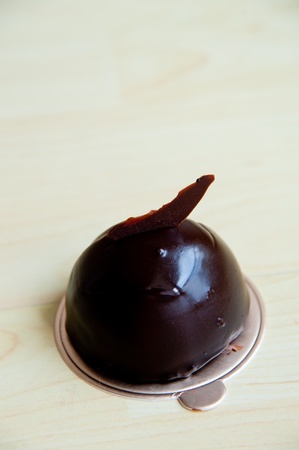 Piece of cake on wood pattern background   Extra Dark Chocolate Mousseの写真素材