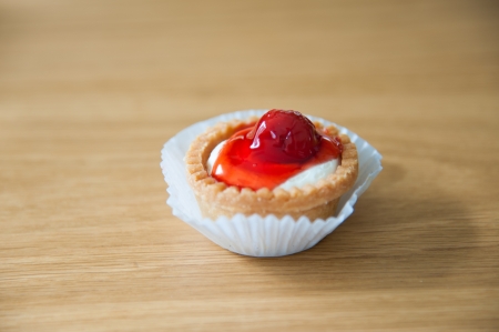 A piece of strawberry tart on wood backgroundの写真素材