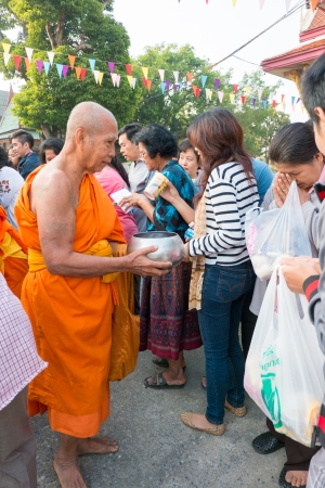 Nonthaburi, THAILAND - Jan 1, 2014    Unidentified Buddhist monks are given food offering from people in the morning for New Year Day  on January 31, 2014 in Sak Yai Temple, Nonthaburi  Thailand のeditorial素材