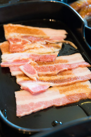 Bacon on black dish