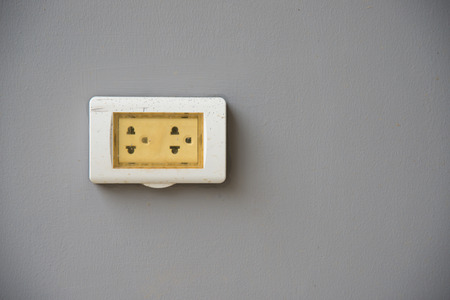 Thailand plug socket with the cover protection on grey backgroundの写真素材