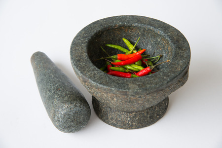 Mortar, Pestle and red chili on a White Backgroundの写真素材