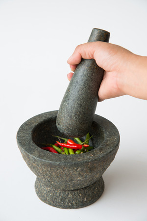 Mortar, Pestle and red chili on a White Backgroundの写真素材