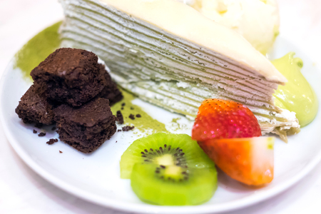 Uji Matcha Crepes Cake with vanilla ice cram, brownies and fruits toppingの写真素材