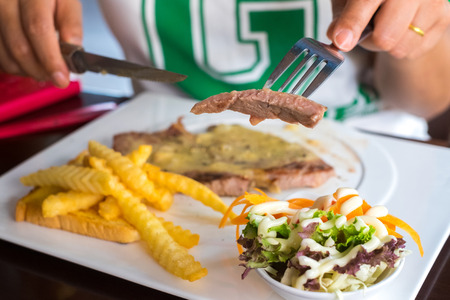 Delicious grilled pork steak on white dishの写真素材