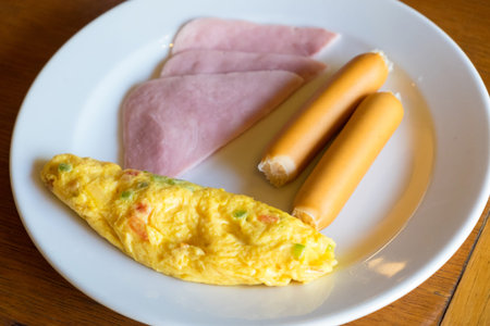 American breakfast with egg, sausages and hamの写真素材