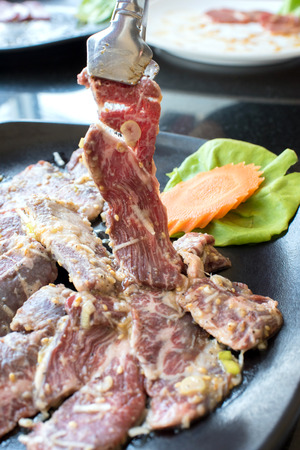 Meat slice (beef) in a black plateの写真素材