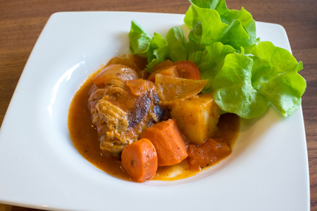 A plate of chicken stew on wooden tableの写真素材