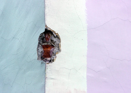 texture multicolored old brick wall, plastered and painted in three colorsの写真素材