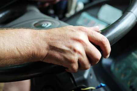 male hands of a large bus driver long haul