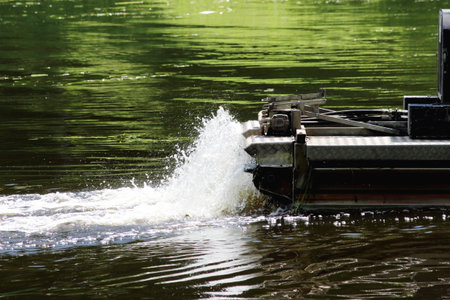 mini dredger is clearing lake algae summer day