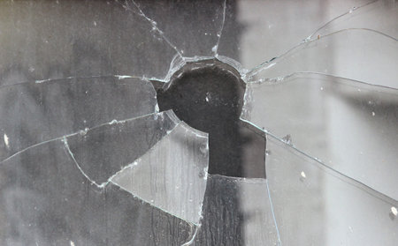 Vandals smashed the glass of the store window.