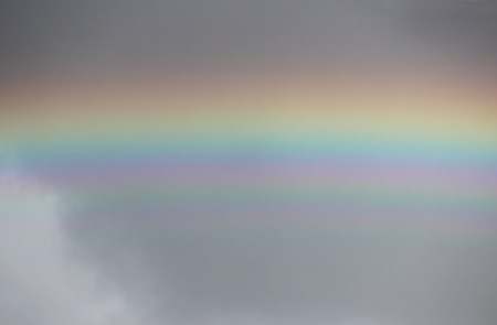 bright colorful wide colorful rainbow after the storm in the gray sky.の写真素材