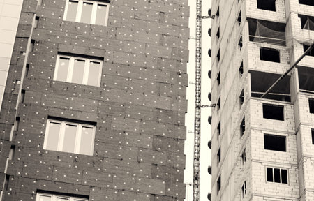 black and white photo windows in a newly built house. wall structure with insulated non-combustible...