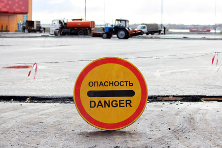 danger warning sign that prohibits the passage to the parking lot, which is repaired. inscription in...
