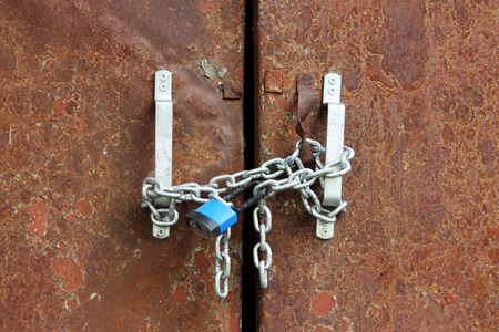 blue lock on the chain rusty door locks transformer stationの写真素材