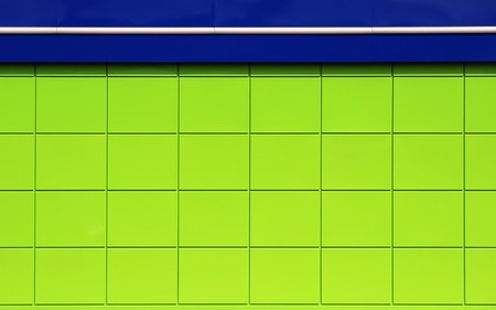 texture of bright green building with a blue roof utility room near the gas station.の写真素材