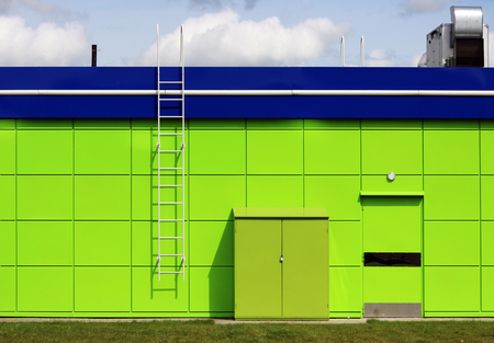 texture of bright green building with a blue roof utility room near the gas station.の写真素材